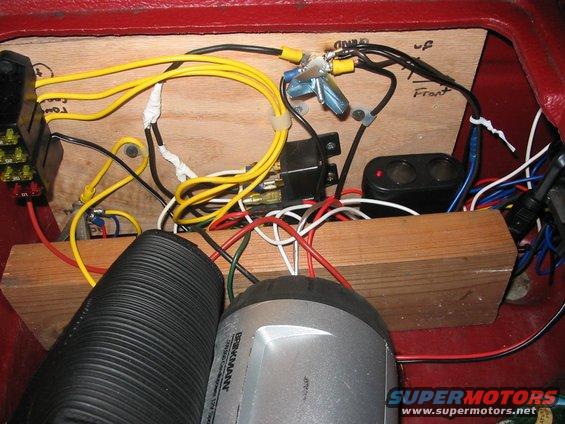 107_0767.jpg inside the center console, fuses to the left, relays in the middle, and a ciggie expander on the bottom right.