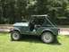1979 Jeep CJ5 - This green 1979 Jeep CJ5 is shown from the side, parked on a grassy area with trees behind it.
