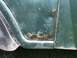 1979 Jeep CJ5 - Close-up of a green vehicle's body panel shows extensive rust and corrosion.