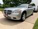2006 Dodge Magnum - A silver 2006 Dodge Magnum is parked on a driveway, with another vehicle visible behind it.