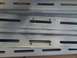 2018 Toyota 4Runner - A close-up view of a gray metal rack with multiple horizontal slots and mounting holes.