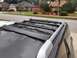 2018 Toyota 4Runner - Aftermarket roof rack installed on a dark SUV, with houses in the background.