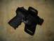 2002 Ford Taurus - A pistol is shown secured in a leather holster against a textured background.