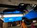 1963 Ford E100 - Underside view of a vehicle's exhaust manifold and freshly painted blue transmission.