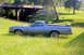 1976 Ford Ranchero - A light blue 1972 Ford Ranchero pickup truck sits in a grassy field next to a concrete structure.