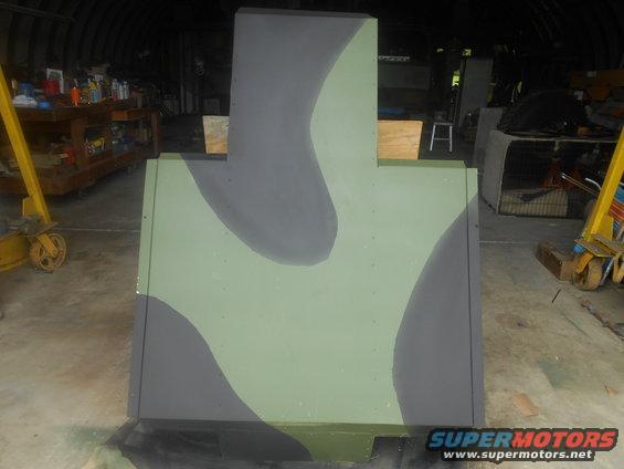 Camouflage target in a garage, painted with green and gray splotches