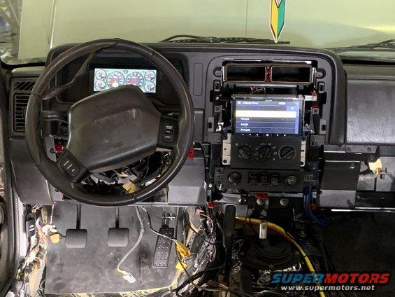Interior dashboard with aftermarket screen and exposed wiring