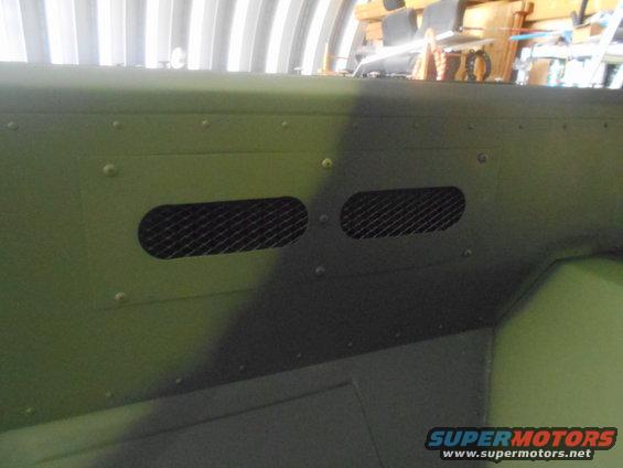 Green interior panel with two oval mesh vents and visible rivets