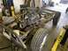 1979 Jeep CJ5 - The chassis and engine of a 1979 Jeep CJ5 are visible, with tires mounted and the vehicle supported by jacks.