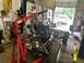 1979 Jeep CJ5 - A mechanic uses an engine hoist to remove the engine from a Jeep CJ frame inside a garage.