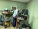 1979 Jeep CJ5 - Man works on a band saw in a workshop setting, surrounded by tools and supplies.