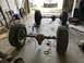 1979 Jeep CJ5 - Disassembled Jeep CJ5 axles and wheels are laid out on the garage floor.