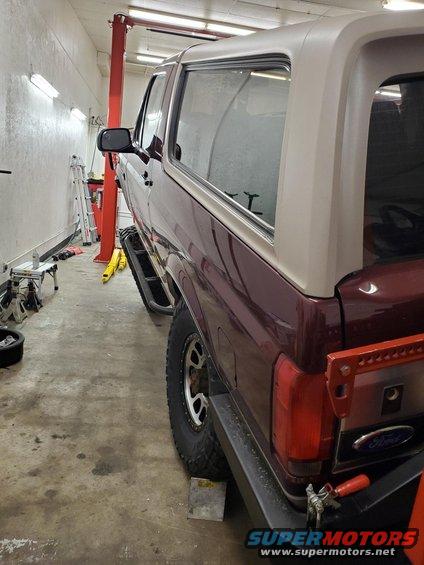 1996 Ford Bronco rear driver side in garage with lift