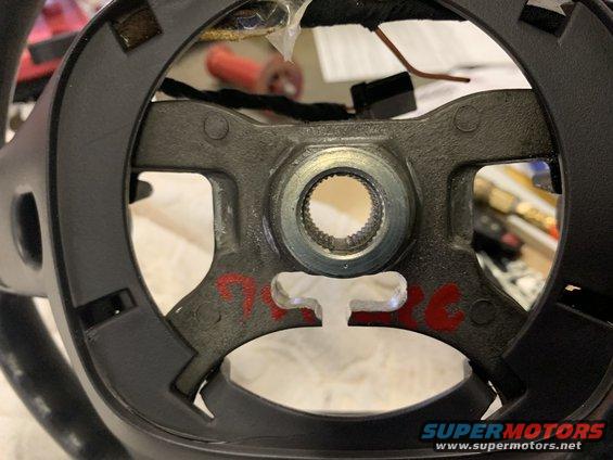 Steering wheel hub with splined shaft opening and red markings. Supermotors.net logo visible