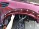 2014 Ford F-150 - Installing a fender flare on a red Ford SVT Raptor, revealing the suspension components and wheel well.