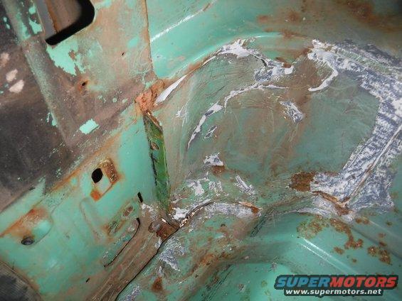 Sloppy seam sealer caked on all around the passenger b-pillar base.