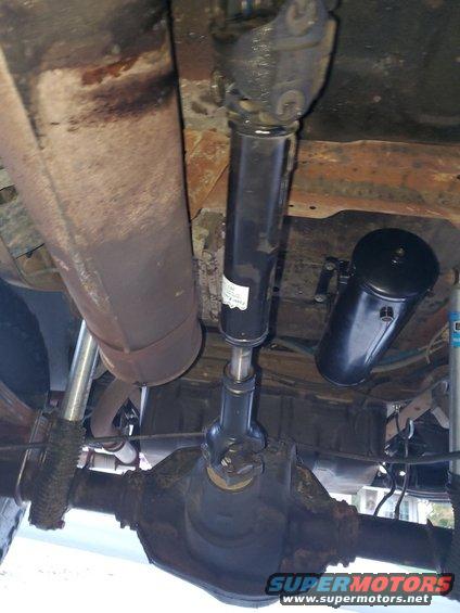 Underside view of driveshaft and differential with an air tank mounted