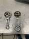 1968 Ford Mustang - Two chrome window crank handles are shown side-by-side on a workbench.