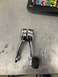 1968 Ford Mustang - These chrome door handles, one with a black rubber grip, are shown on a workbench.