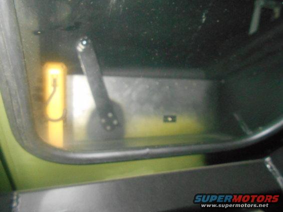 view of a yellow object and a lever inside a vehicle