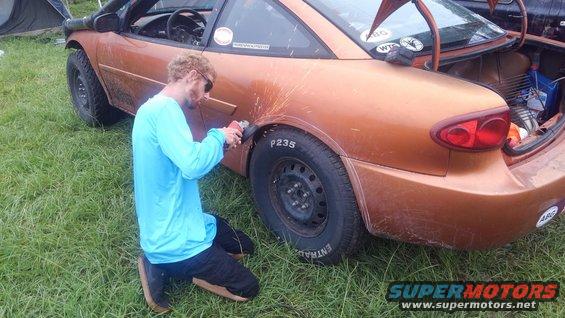 using an angle grinder to gain some more wheel clearance in his Chevy Cavalier 