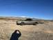 1972 Ford Ranchero - A 1972 Ford Ranchero sits in a dusty, arid landscape under a clear blue sky.