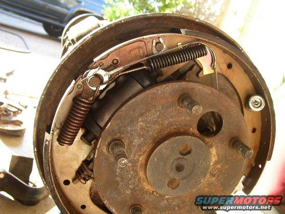Close-up of a rusty drum brake assembly with springs and brake shoes