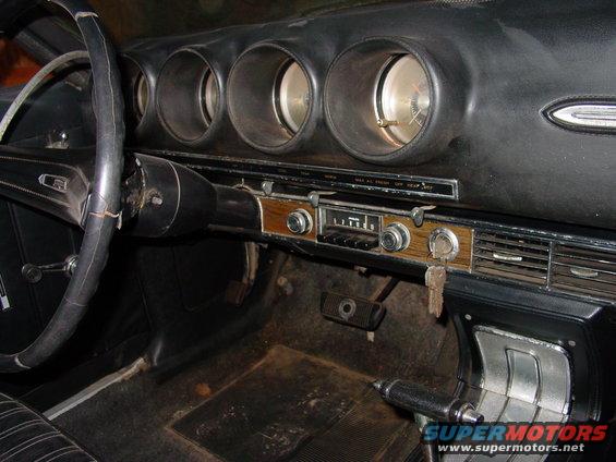 1969 Ford Fairlane interior dashboard with woodgrain trim, radio, and gauges