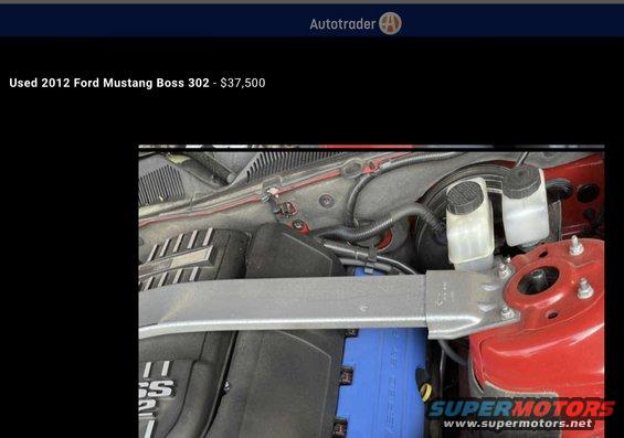 Engine bay with strut tower brace and brake fluid reservoirs