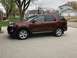 2016 Ford Explorer - This maroon 2016 Ford Explorer is shown from the side in a suburban driveway.