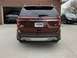 2016 Ford Explorer - The rear of a maroon Ford Explorer is shown, with other vehicles visible in the background and garage.