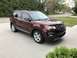 2016 Ford Explorer - A brown 2016 Ford Explorer is parked in a driveway, its front grille and headlights.