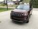 2016 Ford Explorer - A brown 2016 Ford Explorer is parked on a concrete driveway in front of a residential garage.