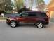 2016 Ford Explorer - Side profile of a red 2016 Ford Explorer parked in a suburban driveway.