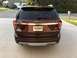 2016 Ford Explorer - The rear of a maroon Ford Explorer SUV is shown parked in a driveway.