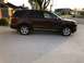 2016 Ford Explorer - A brown Ford Explorer is parked on a concrete driveway in front of a house.