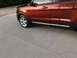 2016 Ford Explorer - The side profile of a red SUV is shown, reflecting the surroundings in its paint.
