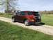 2016 Ford Explorer - Rear view of a brown 2016 Ford Explorer on a gravel driveway with a house in the background.