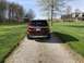 2016 Ford Explorer - A red 2016 Ford Explorer is parked on a gravel driveway in front of a house and barn.