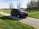 2016 Ford Explorer - This maroon 2016 Ford Explorer is parked on a gravel driveway surrounded by green grass and trees.