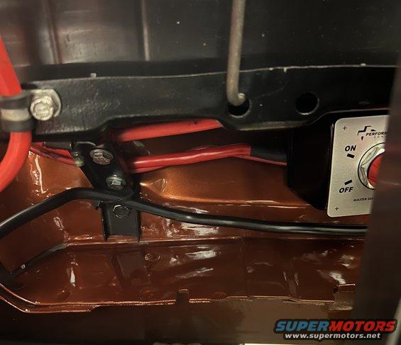 Master disconnect switch with ON/OFF labels, red and black wires, and orange painted metal