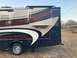 2015 Ford F-550 - Side view of a motorhome with a "FLAIR" decal and extended awning.