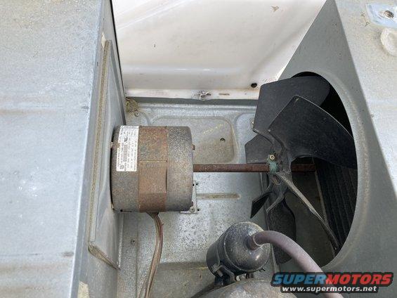 Air conditioner motor and fan assembly with visible label