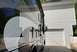2015 Ford F-550 - A motorhome is parked in front of a residential garage on a sunny day.