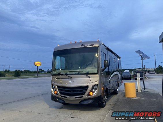 Tan motorhome with FLAIR badging, front view