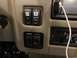 2015 Ford F-550 - Interior dashboard view showing various control switches for radio, generator, and cameras, alongside climate controls.