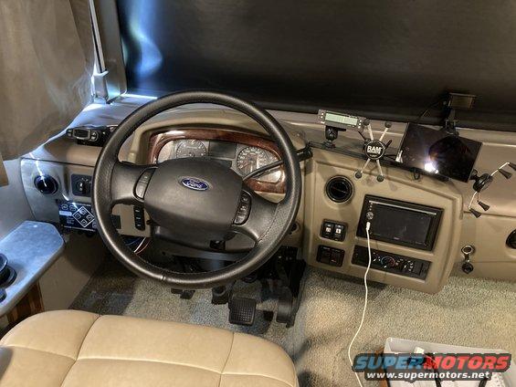 RV dashboard with Ford steering wheel, tablet mount, and radio