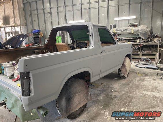 Ford Bronco in body shop, primer coat on, interior visible