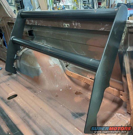 Black roll bar installed in the bed of a pickup truck