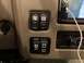 2015 Ford F-550 - Interior view of dashboard switches and controls, including power, radio, generator, and camera functions.
